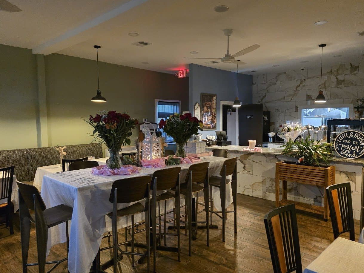 Bright dining room with set tables and fresh flowers