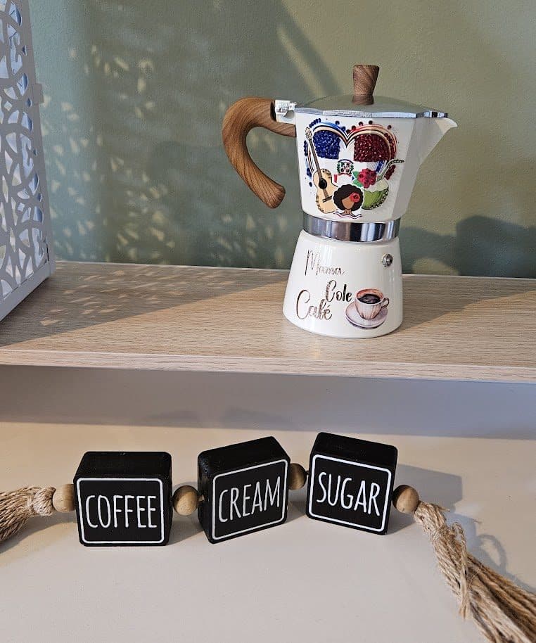 Colorful stovetop espresso pot with coffee, cream, and sugar